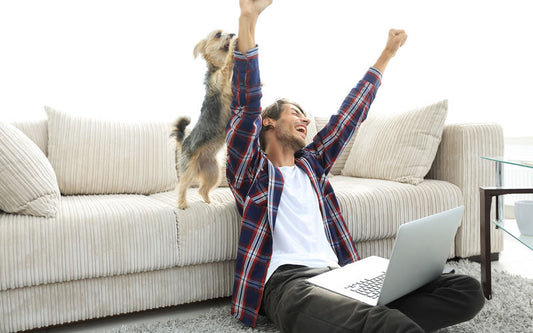 Rejoicing man and his dog celebrating more studies showing dogs will be healthier being plant-based