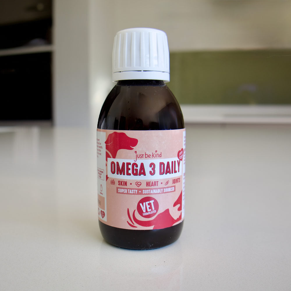 Bottle of 'Omega 3 Daily' supplement with a pink label on a white surface