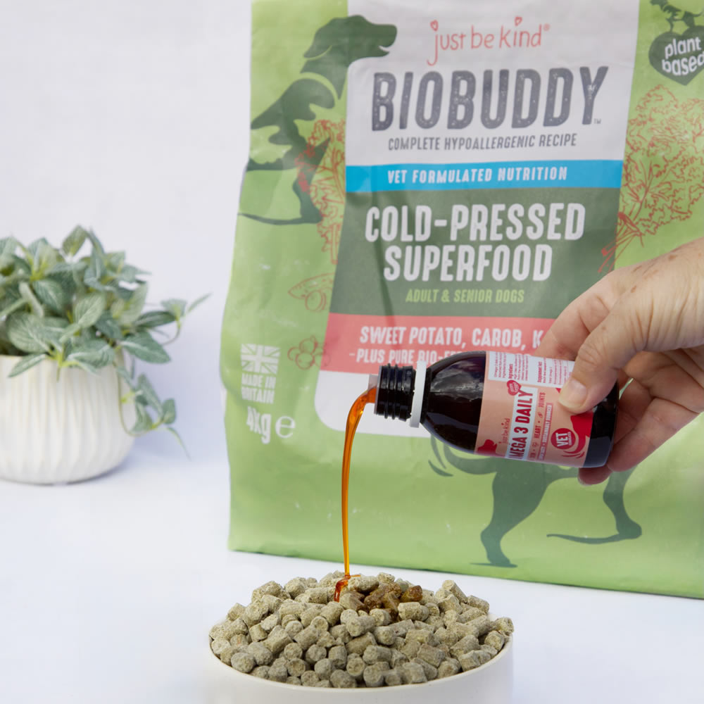 BioBuddy cold-pressed superfood and Omega 3 Algae oil being poured over a bowl of BioBuddy nuggets