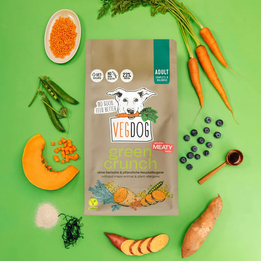 VegDog green crunch4kg  dog food package with vegetables on a green background