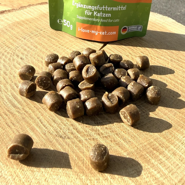 Veggie snack package for cats with snacks on a wooden surface  - chewy cat treats made with microbial fermentation protein